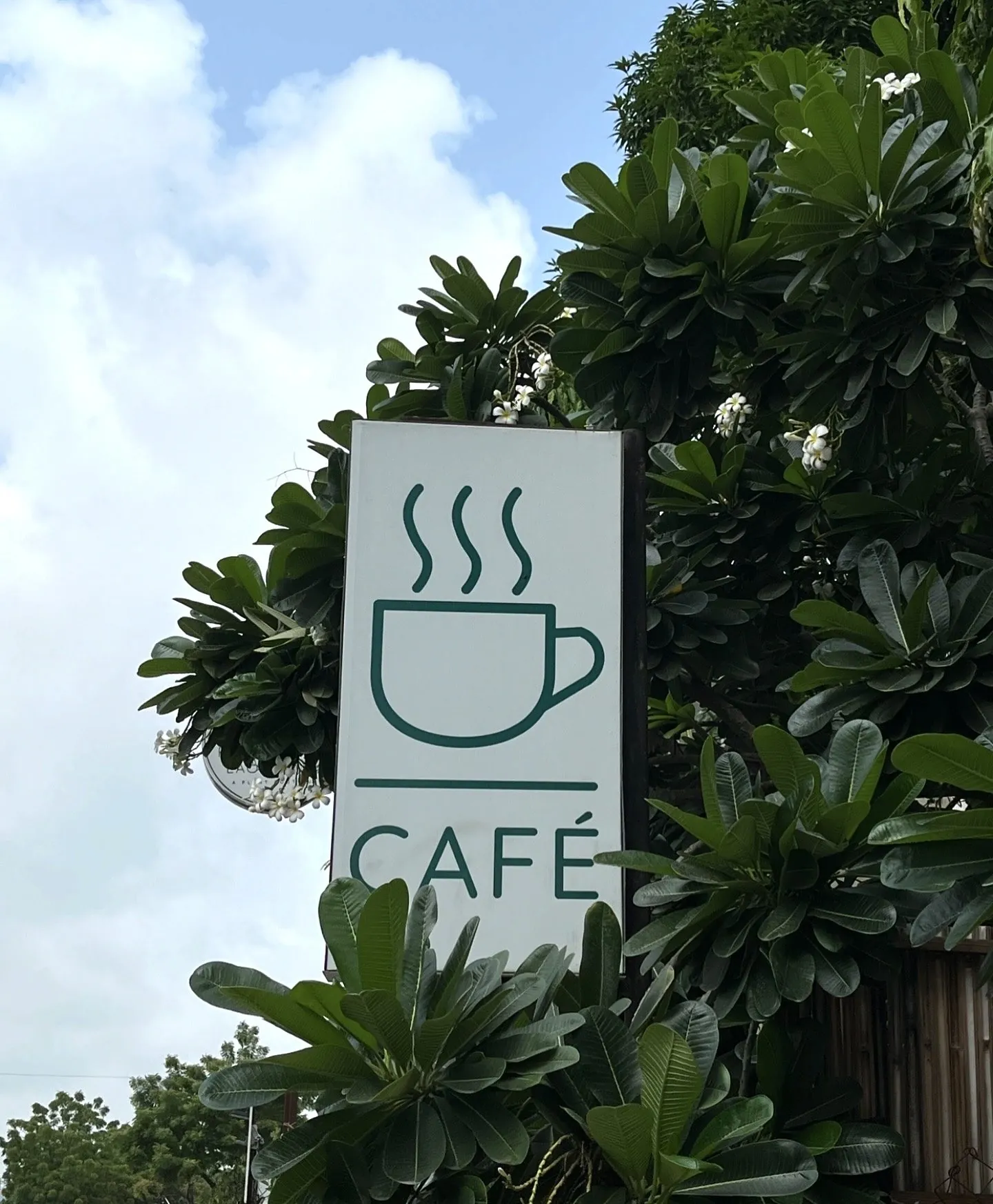 Café signage among the leaves